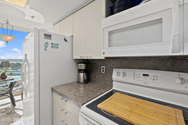 kitchen featuring tasteful backsplash, white appliances, pendant lighting, and white cabinets