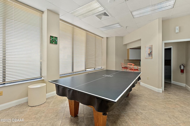 recreation room with a drop ceiling and light tile patterned floors