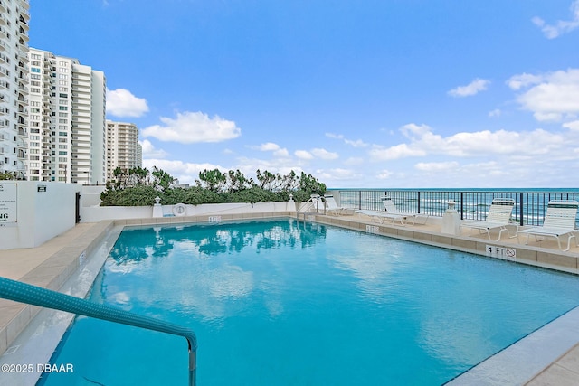 view of swimming pool featuring a water view