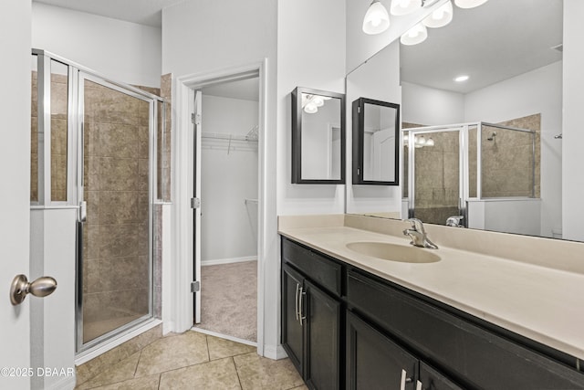 bathroom with tile patterned floors, vanity, and walk in shower