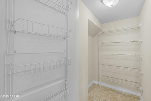 walk in closet featuring tile patterned flooring