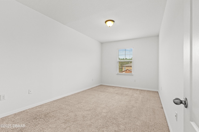 unfurnished room with light carpet