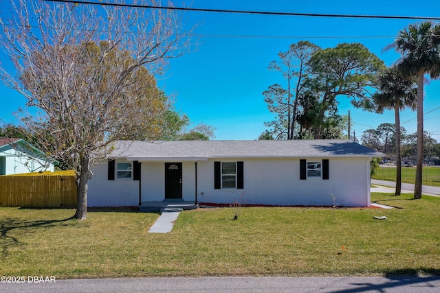 single story home featuring stucco siding, a front yard, and fence