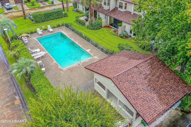 view of swimming pool with a lawn and a patio area