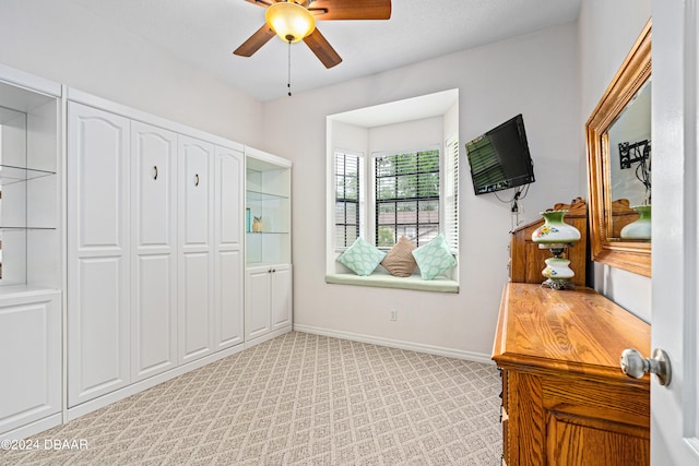 bedroom featuring a closet, light carpet, and ceiling fan