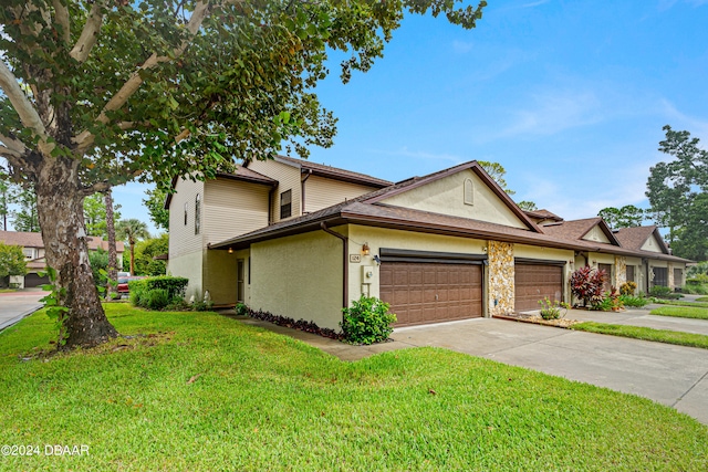 view of front of property featuring a garage and a front lawn