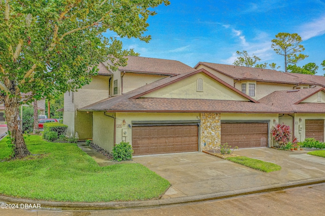 view of front facade with a garage and a front yard