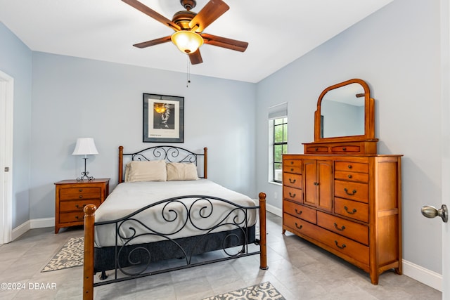 bedroom featuring light tile patterned flooring and ceiling fan