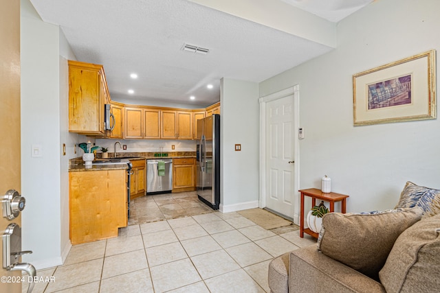 kitchen featuring light tile patterned flooring, sink, and appliances with stainless steel finishes