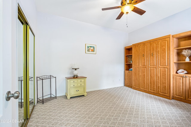 unfurnished bedroom featuring ceiling fan and light carpet