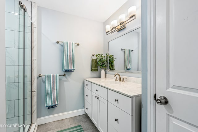 bathroom with tile patterned flooring, vanity, and a shower with shower door