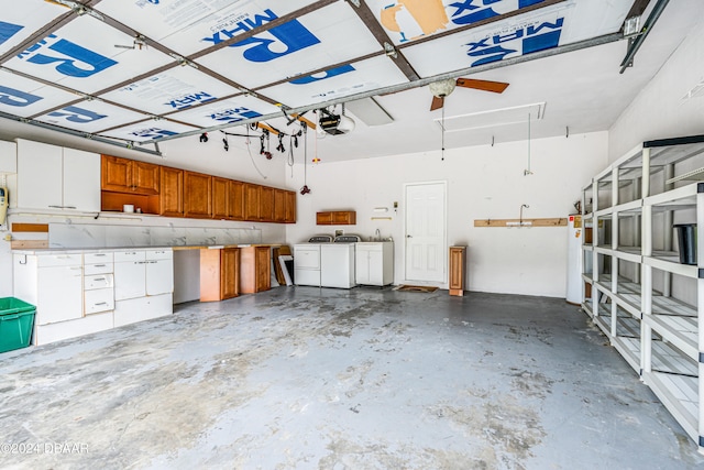 garage featuring washer and clothes dryer, a garage door opener, and water heater