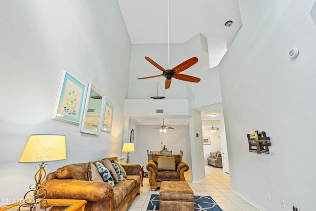 living room with a towering ceiling and light tile patterned flooring