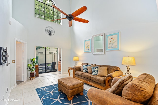 living room with a towering ceiling, a wealth of natural light, and light tile patterned floors