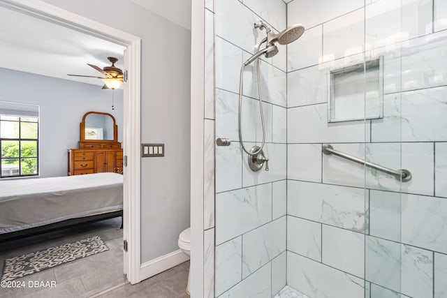 bathroom featuring toilet, ceiling fan, and tiled shower