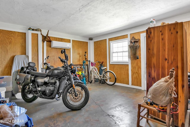 garage with wooden walls and an AC wall unit