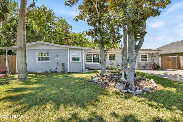 ranch-style home featuring a patio and a front lawn