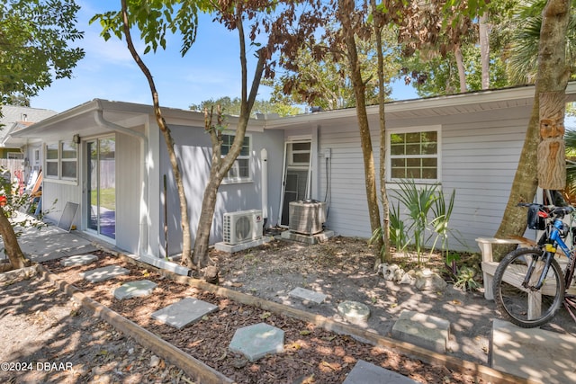 rear view of property with cooling unit and ac unit