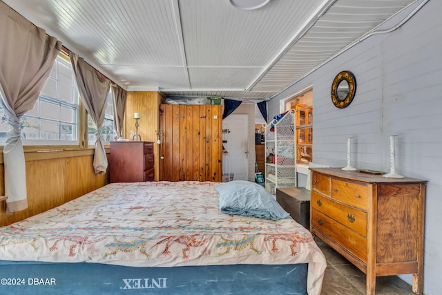 bedroom with wooden walls