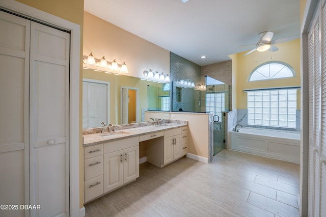 bathroom featuring a shower stall, ceiling fan, vanity, and a garden tub