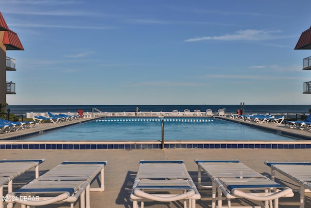 view of swimming pool with a water view