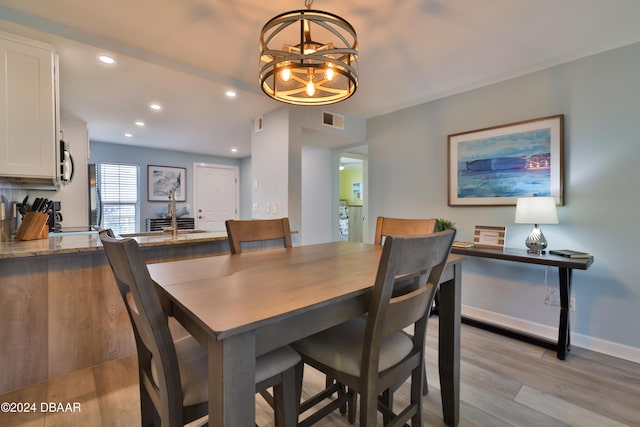 dining room featuring a chandelier and light hardwood / wood-style floors