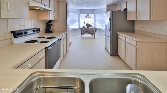 kitchen featuring white electric range oven, light brown cabinets, light countertops, freestanding refrigerator, and under cabinet range hood