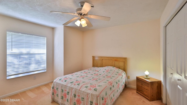 bedroom with a closet, baseboards, multiple windows, and light carpet