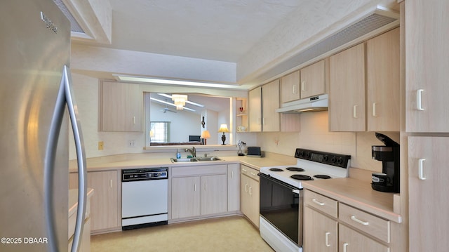 kitchen with light brown cabinetry, a sink, light countertops, under cabinet range hood, and white appliances