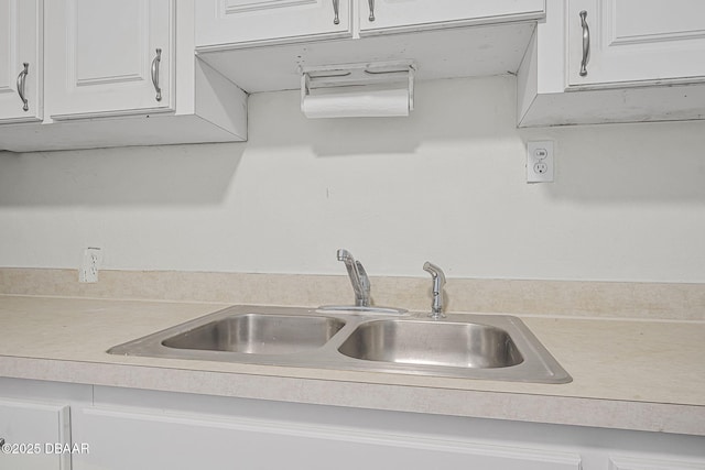 229 S Adams St, Daytona Beach, FL 32117 - kitchen featuring a sink, light countertops, and white cabinets