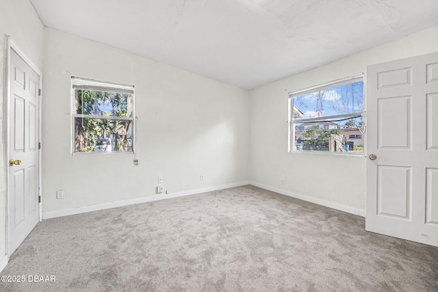 229 S Adams St, Daytona Beach, FL 32117 - unfurnished bedroom featuring multiple windows, carpet, and baseboards