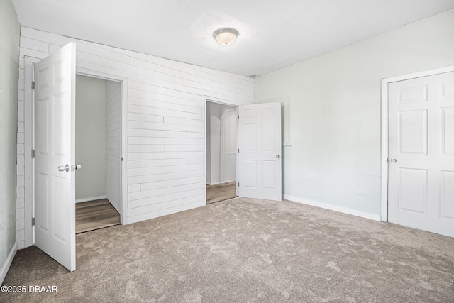 229 S Adams St, Daytona Beach, FL 32117 - unfurnished bedroom with carpet floors and wood walls