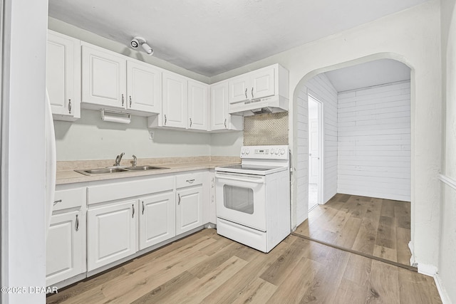 229 S Adams St, Daytona Beach, FL 32117 - kitchen featuring white range with electric stovetop, under cabinet range hood, a sink, white cabinets, and light countertops