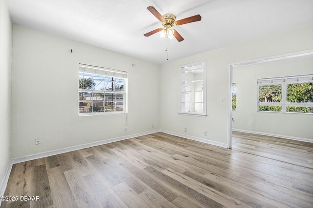 229 S Adams St, Daytona Beach, FL 32117 - empty room featuring a ceiling fan, wood finished floors, and baseboards