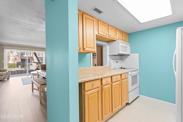 kitchen with decorative backsplash, white appliances, and light brown cabinetry