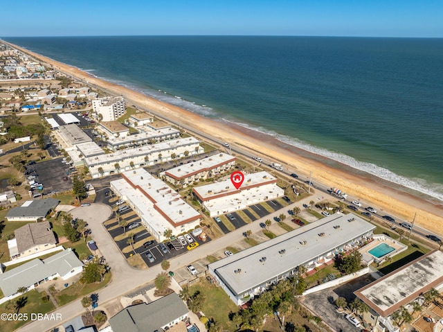 birds eye view of property featuring a water view and a view of the beach