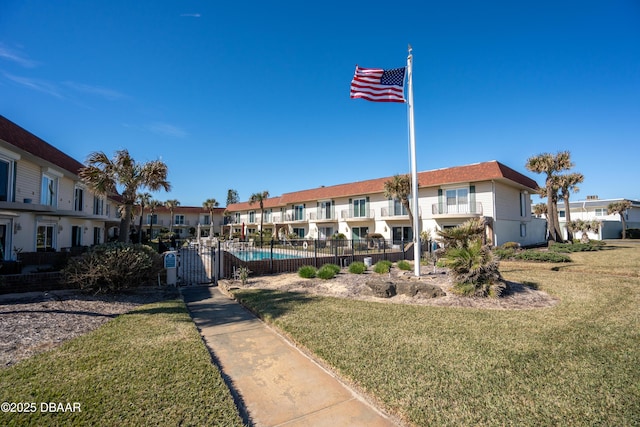 view of property with a fenced in pool