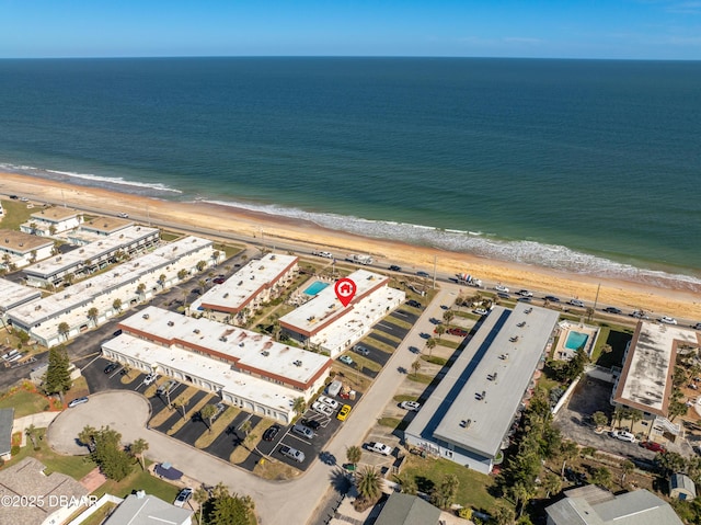 drone / aerial view with a water view and a beach view