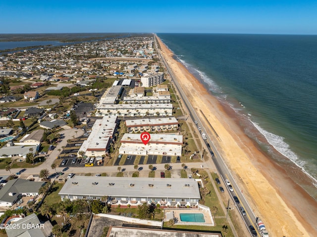 drone / aerial view with a water view and a beach view