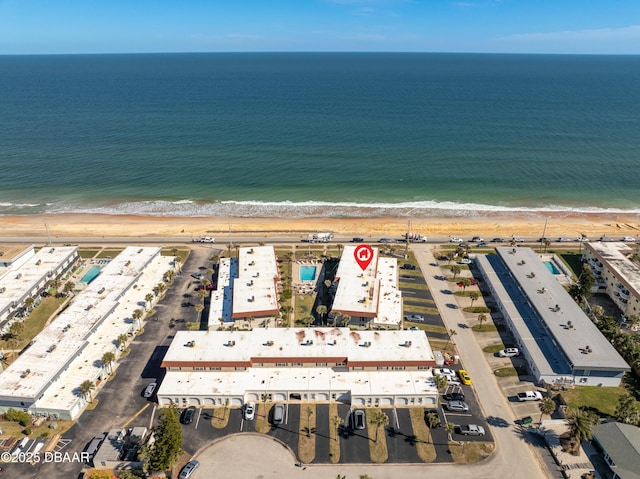 drone / aerial view with a water view and a view of the beach