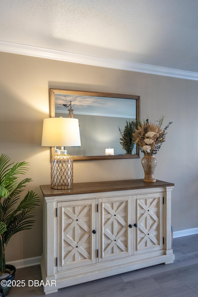 interior details featuring wood-type flooring and crown molding