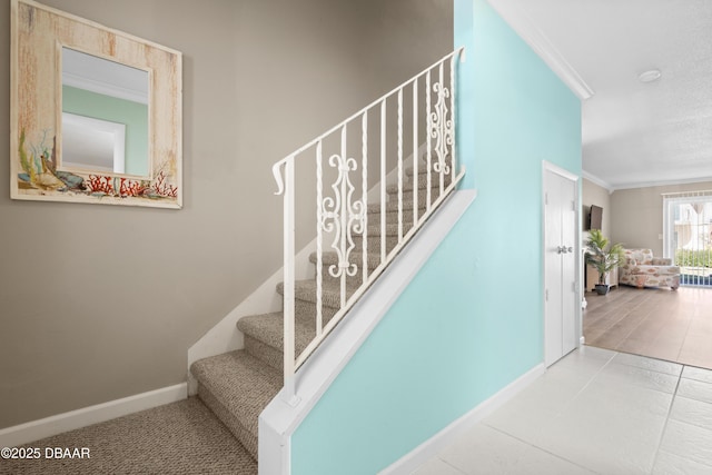 staircase featuring ornamental molding and tile patterned flooring