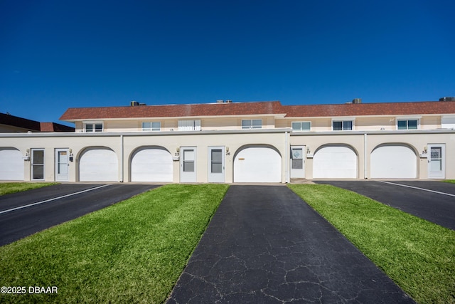 view of property featuring a front lawn