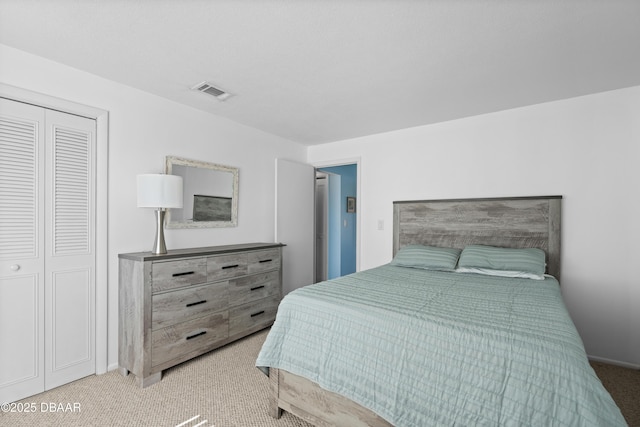 bedroom with light colored carpet and a closet