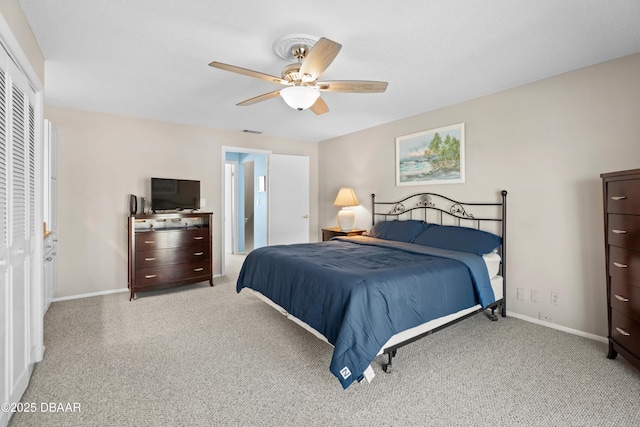 carpeted bedroom with ceiling fan and a closet