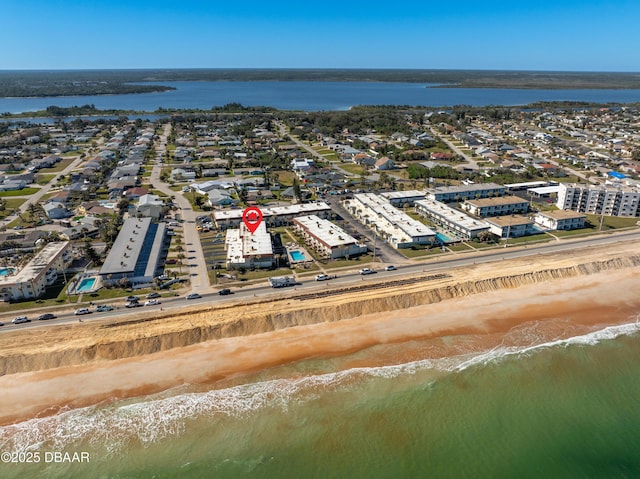 drone / aerial view with a water view and a view of the beach