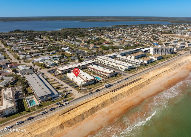 drone / aerial view featuring a water view and a beach view