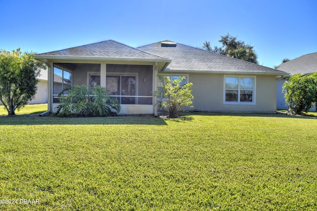 ranch-style house featuring a front yard and a sunroom