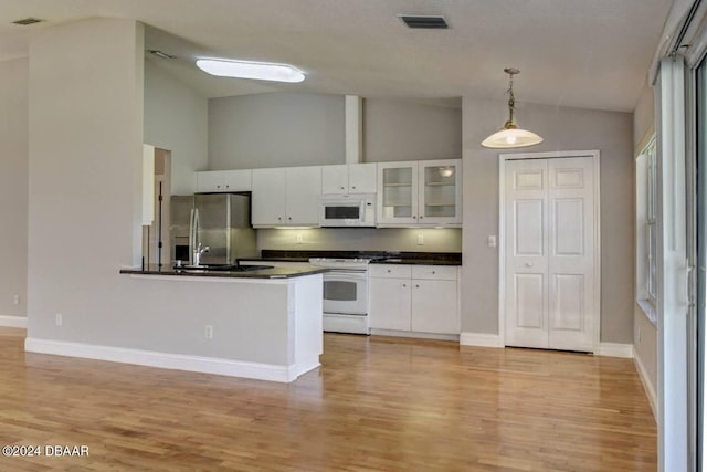 kitchen with white cabinetry, light wood-type flooring, white appliances, and hanging light fixtures