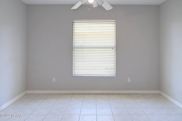 tiled empty room with ceiling fan